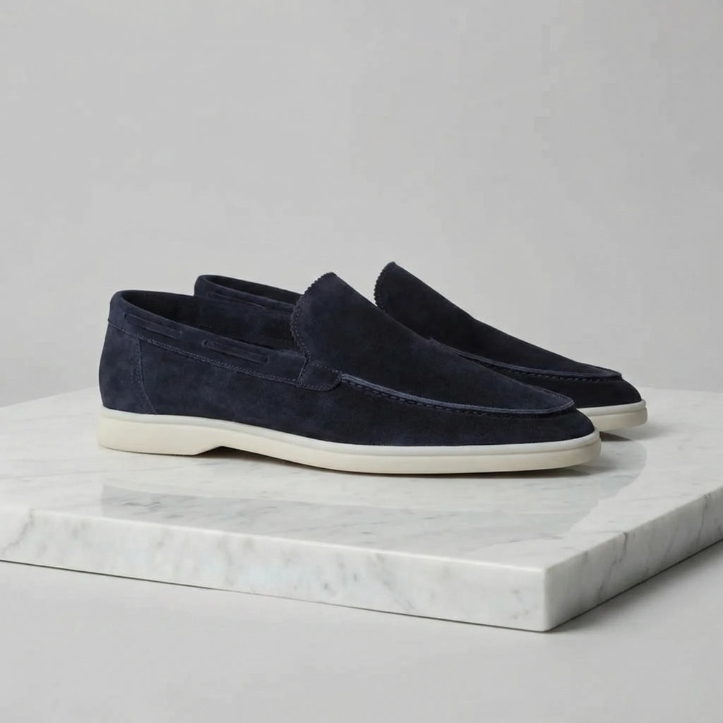 Rear view of yacht blue suede loafers showing the heel shape and cream sole