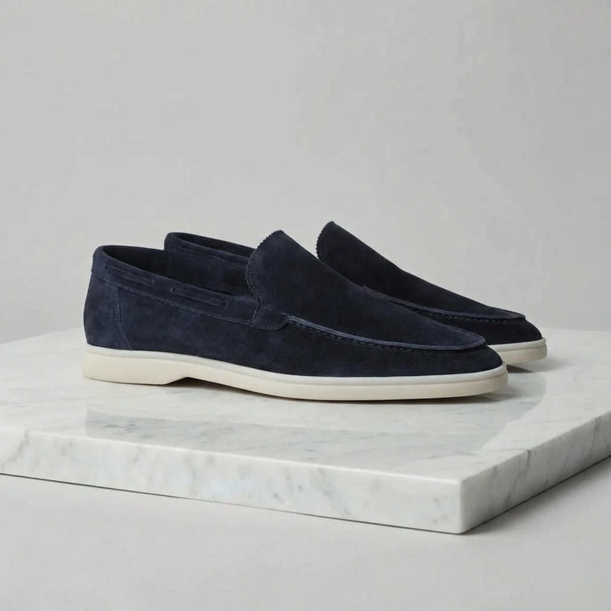 Rear view of yacht blue suede loafers showing the heel shape and cream sole