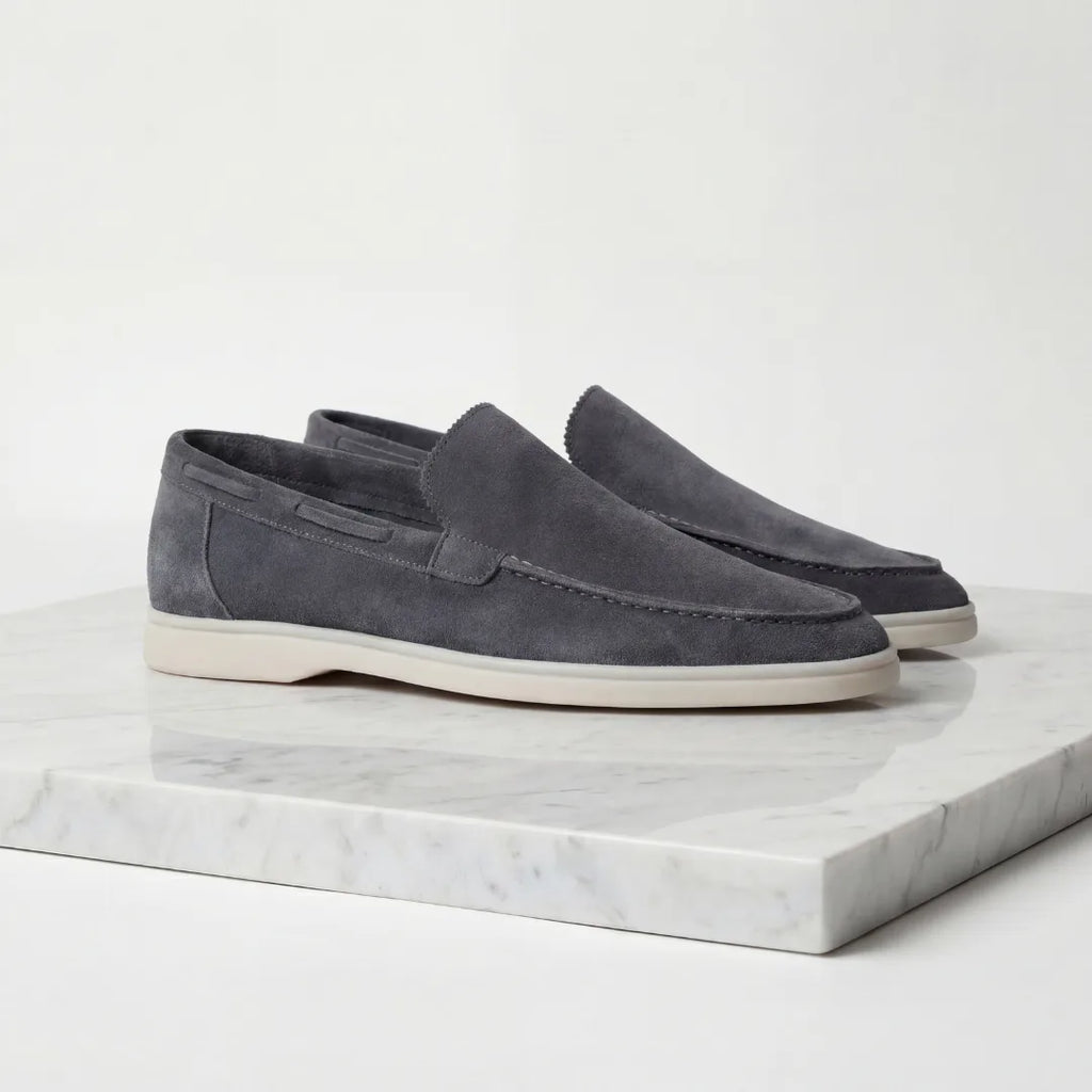 Front angled view of taupe suede loafers highlighting the rounded toe shape