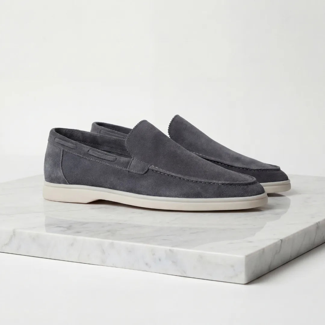 Front angled view of taupe suede loafers highlighting the rounded toe shape