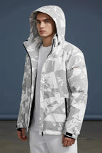 Front view of a man wearing a grey and white camo print hooded jacket with the hood up over a light grey tee