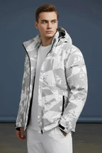 Three-quarter view of the grey camo hooded jacket unzipped, hands in pockets, showing the relaxed fit