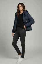 Three-quarter view of a navy puffer jacket showing the quilted panels, hood and zippered chest pocket detail