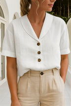 Close-up front view of a white linen-look blouse with notch collar, three tortoiseshell buttons and short cuffed sleeves