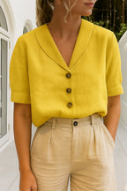 Bright yellow blouse with soft collar, button-front placket and turned-back cuffs on short sleeves