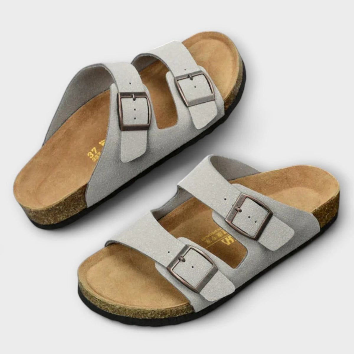 Pair of light grey two-strap sandals viewed from above, showing the textured upper and tan cork footbed