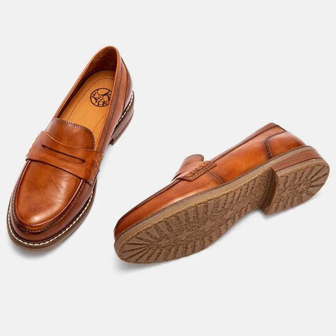 Top view and sole view of tan loafers showing the cushioned tan insole and textured rubber outsole tread