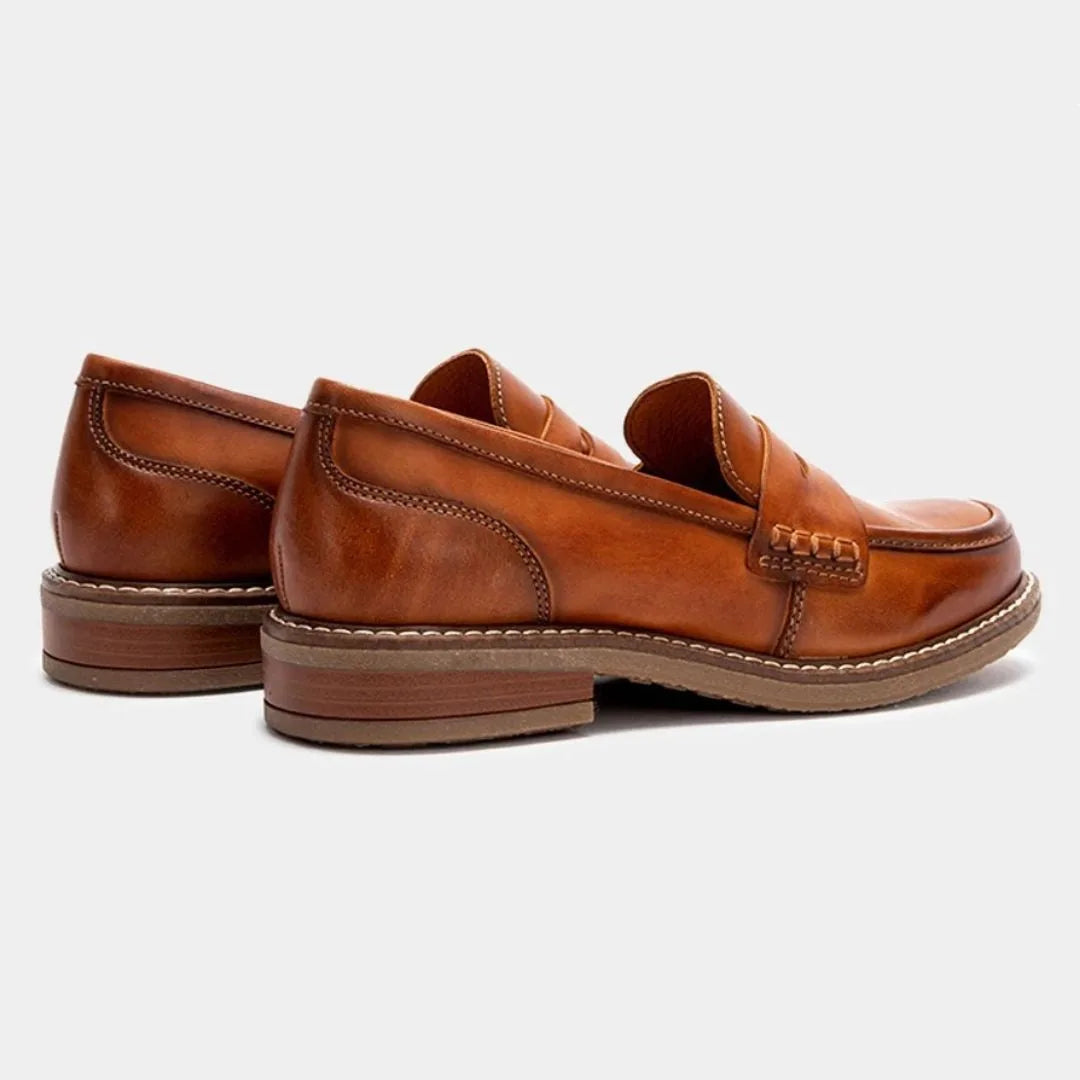 Rear three-quarter view of tan leather loafers highlighting the stacked heel and clean back seam