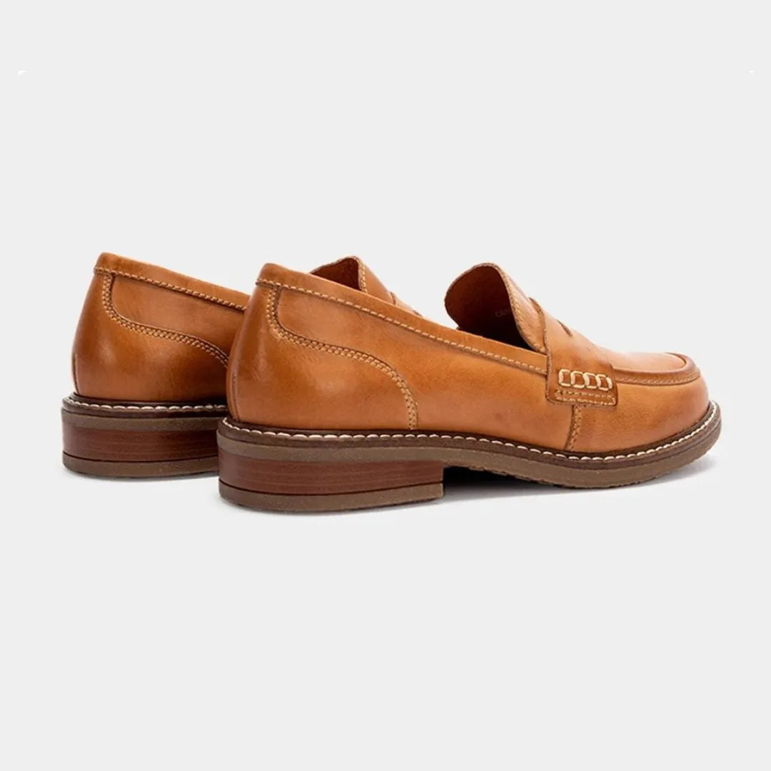 Close side profile of tan leather loafers showing the heel height and hand-stitched sole edge