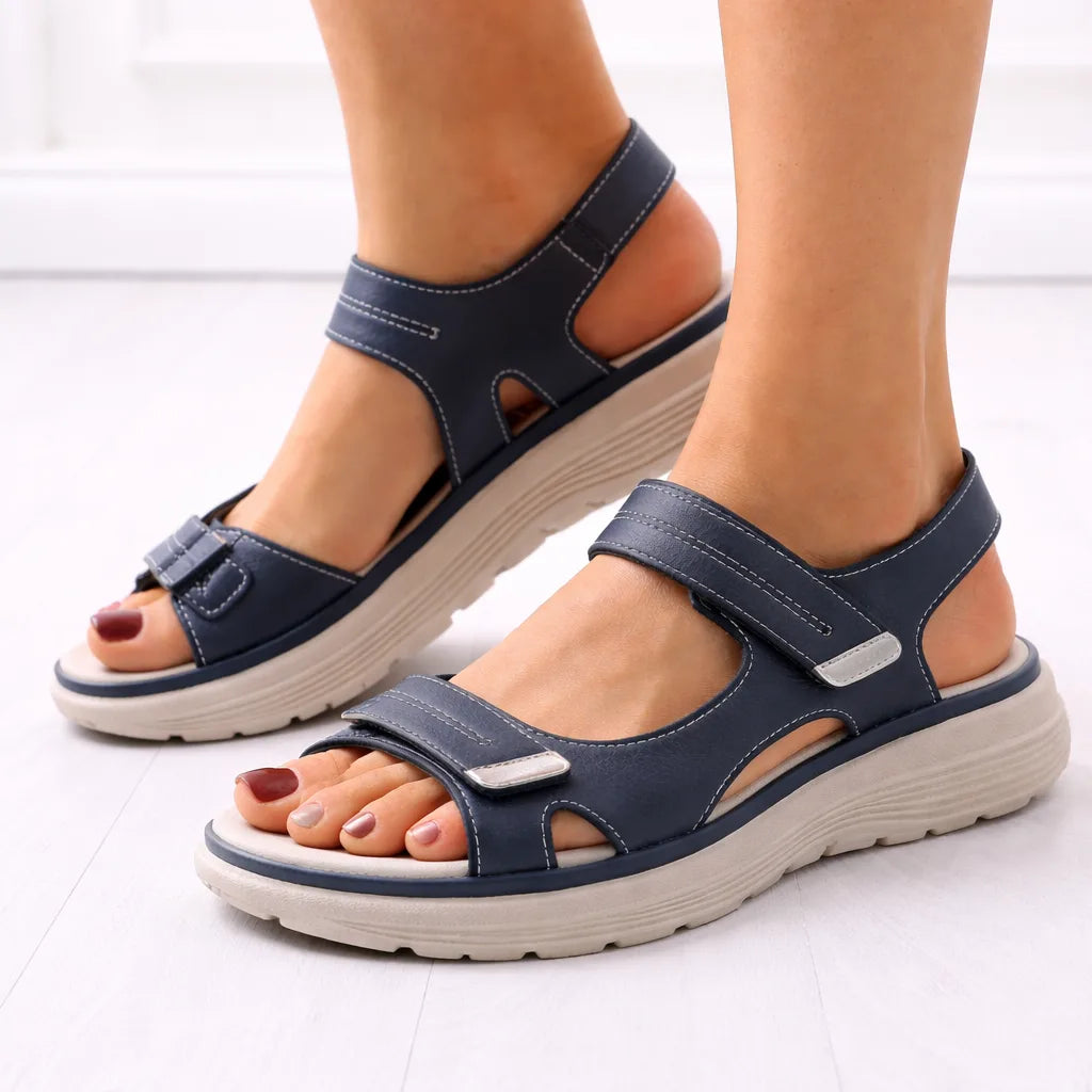 Side view of navy blue strap-style platform sandal with adjustable touch-fasten straps and chunky beige cushioned sole