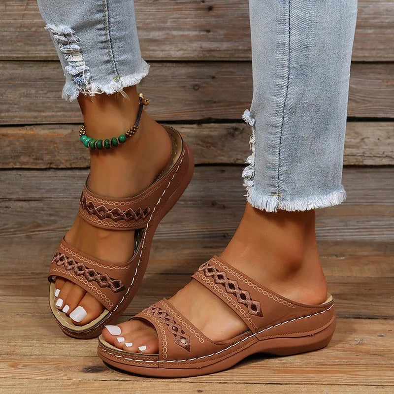 Dark brown leather-look wedge sandals with woven diamond cutouts and tan cork-style sole