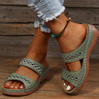 Sage green double-strap wedge sandals with embroidered diamond detail and contrast stitching
