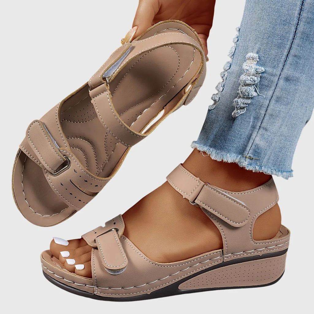 Khaki beige wedge sandal, close-up on the stacked wedge heel and ankle strap buckle