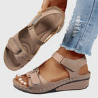 Khaki beige wedge sandal, close-up on the stacked wedge heel and ankle strap buckle