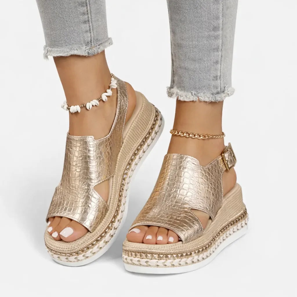 Front view of gold croc-effect wedge sandals with slingback buckle and espadrille wrapped platform sole