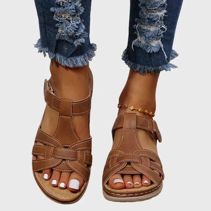 Front-facing pair of tan brown strappy sandals showing open toe design and woven front straps