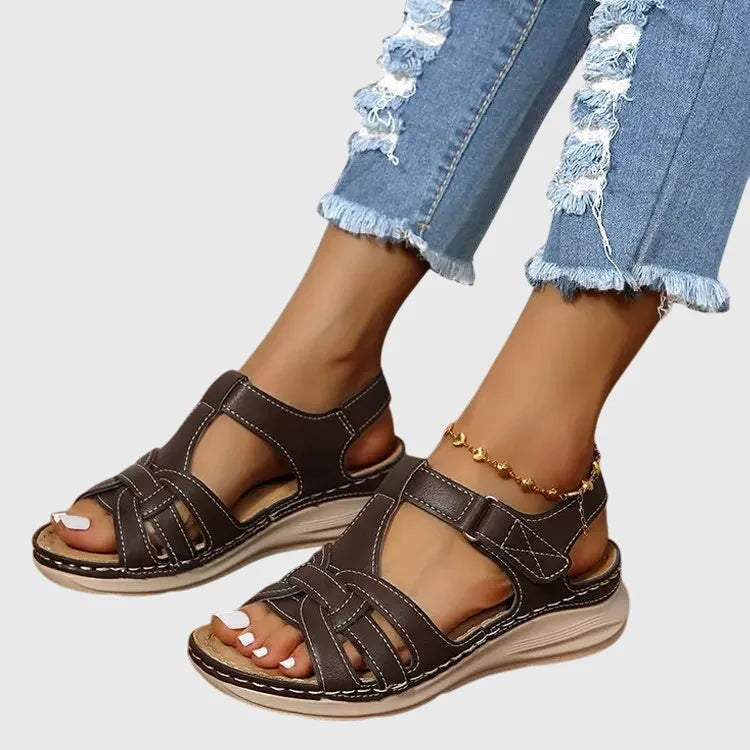 Angled view of dark brown gladiator-style sandals highlighting the crisscross strap detail and foam sole
