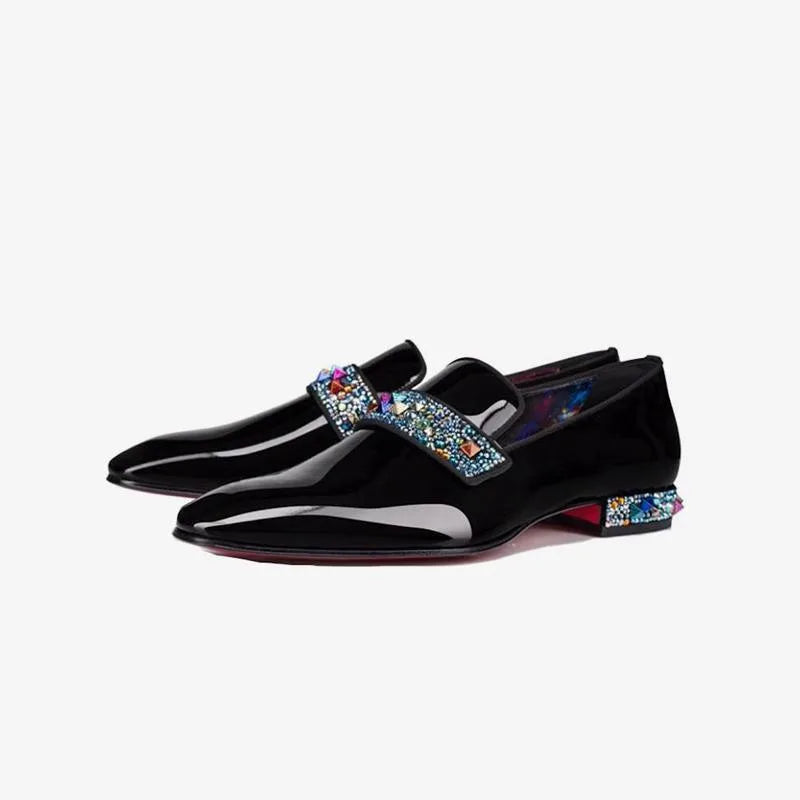 Side pair view of glossy black patent loafers with a jewel-studded strap and matching crystal-embellished heel