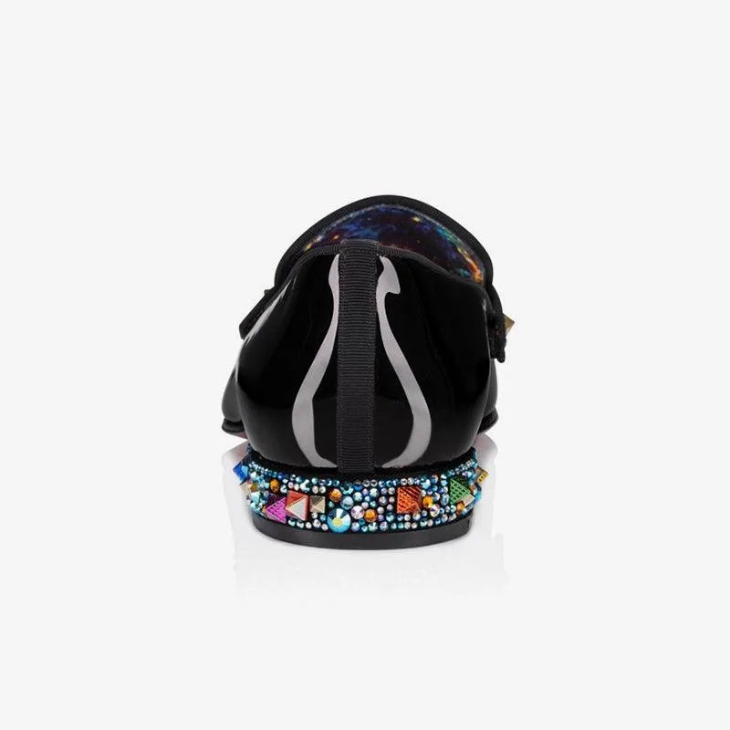 Rear view of a black patent loafer showing the galaxy-print heel lining and crystal-studded heel block