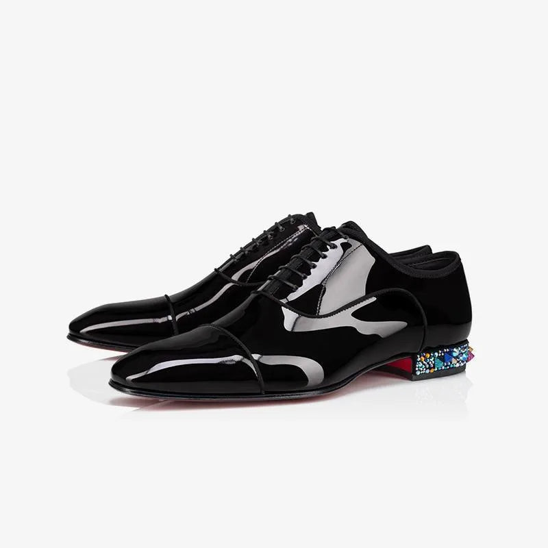 Pair of black patent leather lace-up oxfords with crystal-embellished heels and a sleek pointed toe