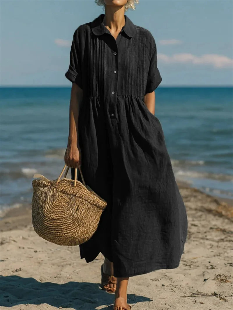Side angle of the model on the beach showing the flowing hemline and relaxed fit of the maxi shirt dress