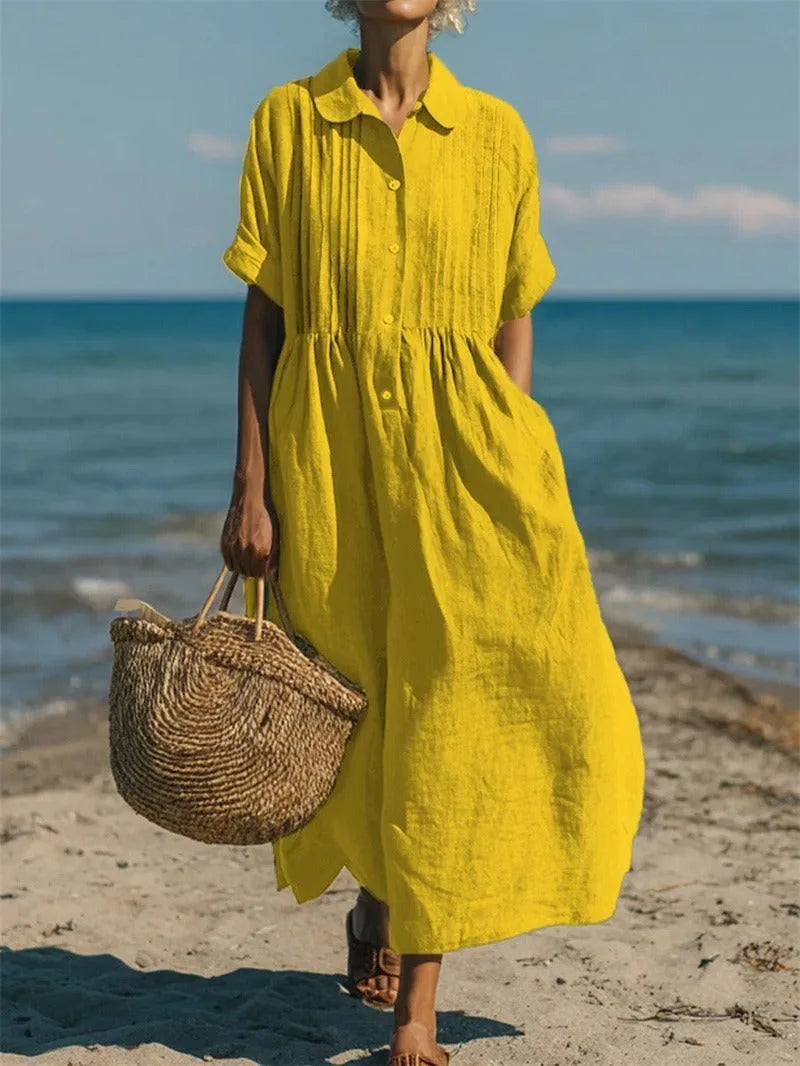Close-up front view of the dress in white showing the button-down placket and vertical pintuck stitching
