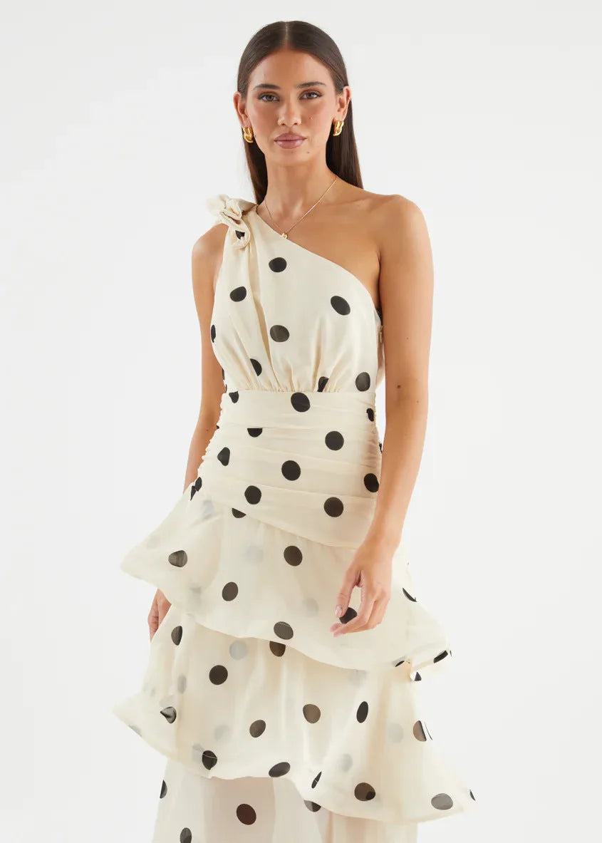 Close-up front view highlighting the shoulder bow, polka dot print and draped bodice of the dress