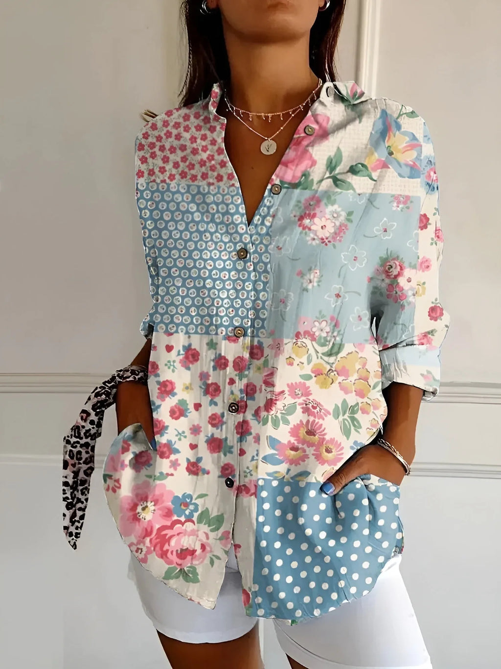 Patchwork-print blouse mixing pink florals, polka dots and gingham panels in soft blue and white tones