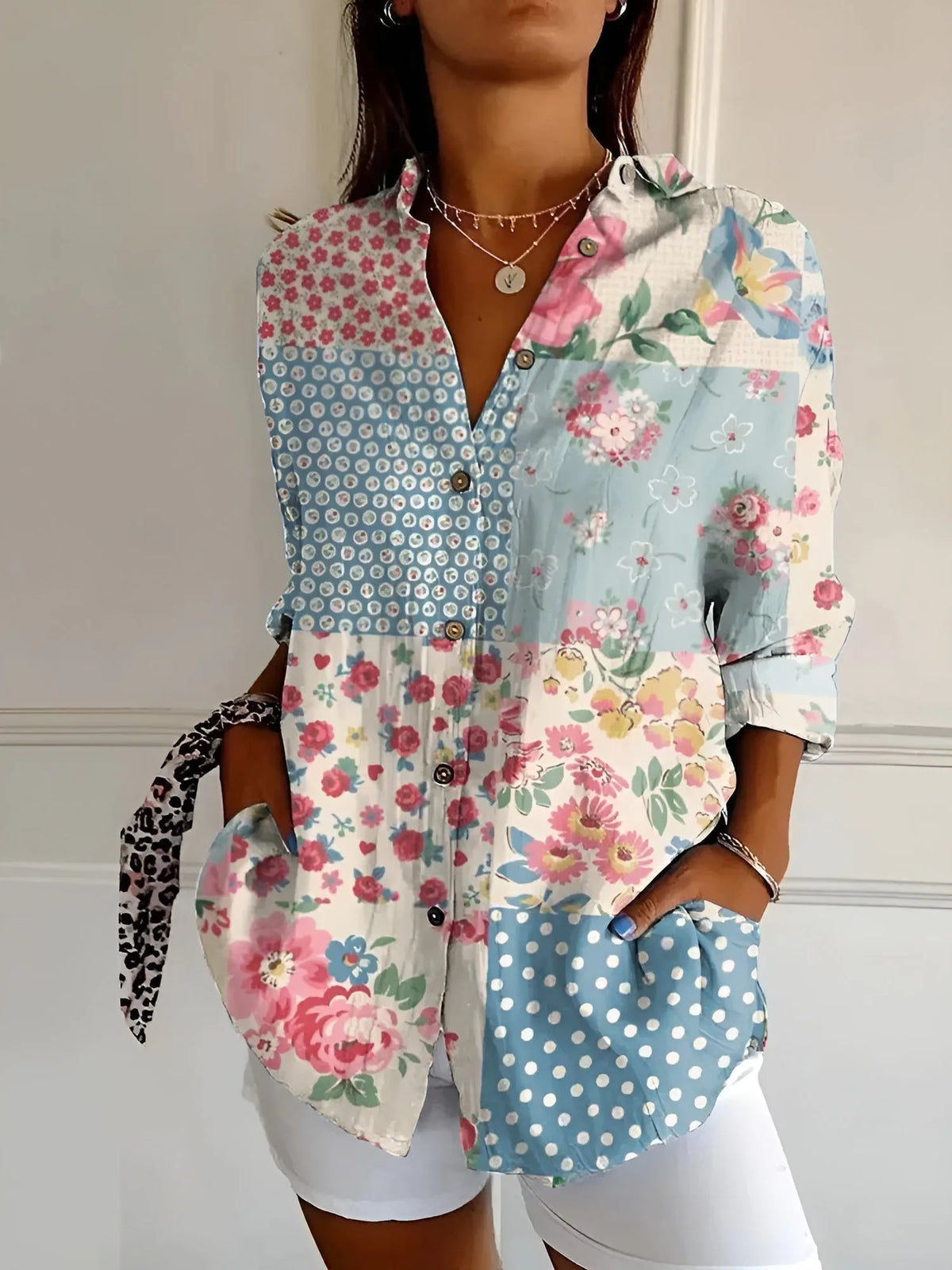 Patchwork-print blouse mixing pink florals, polka dots and gingham panels in soft blue and white tones