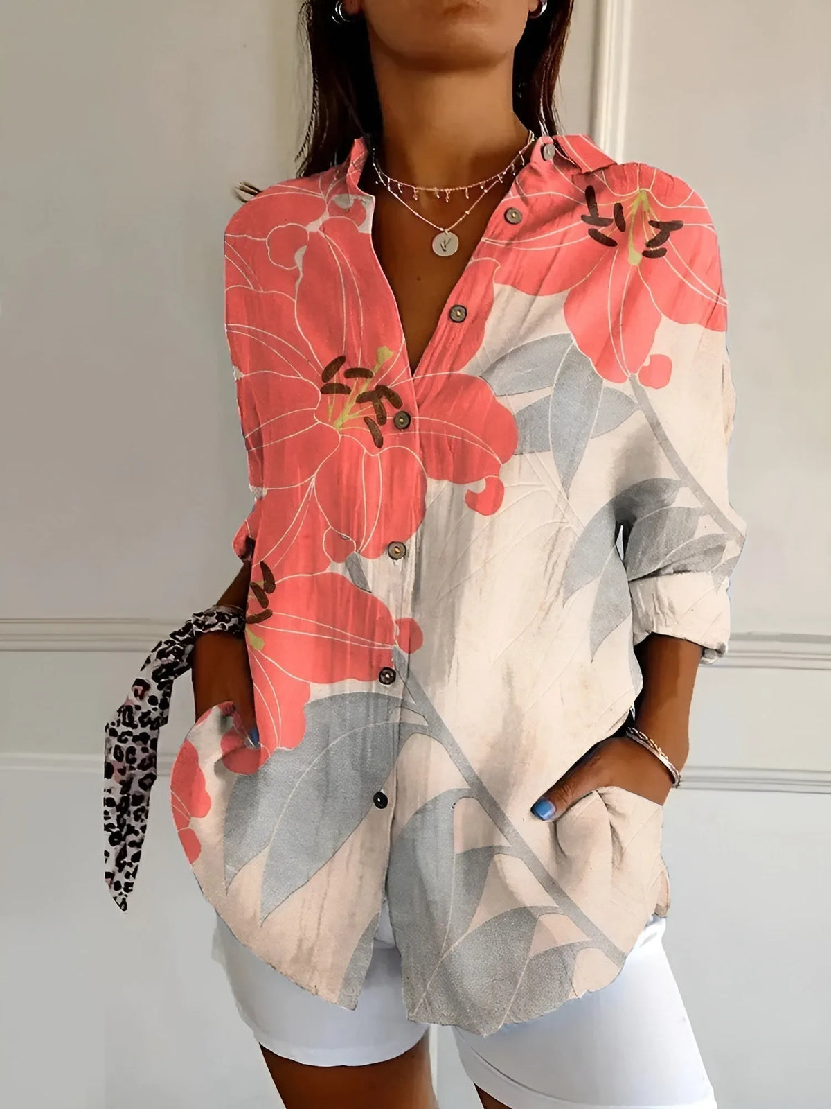 Coral and grey blouse featuring an oversized lily and leaf print across the front panels