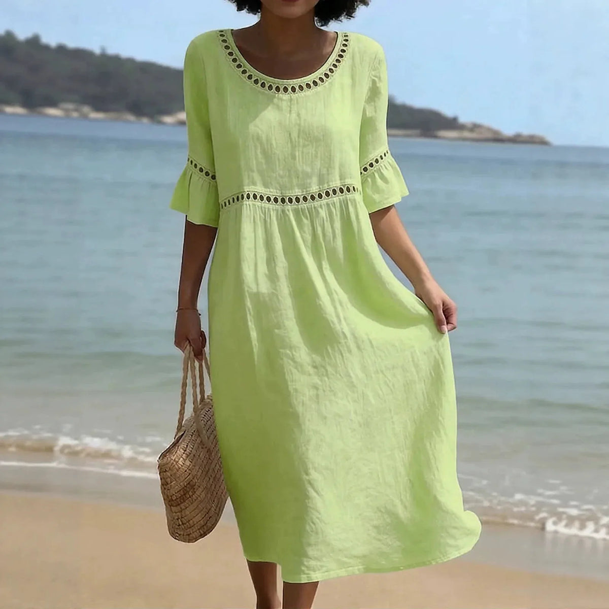 Close-up front view of a lime green linen-style midi dress with hollow out trim along the collar and sleeves
