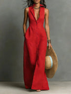 Front view of a sleeveless red collared maxi dress with button-front closure, worn with a straw hat