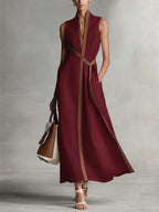 Burgundy sleeveless maxi dress with tan contrast trim, V-neckline and mandarin collar, full-length front view