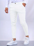 Front view of white slim fit chino pants worn with white shirt and white sneakers