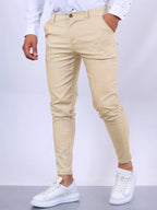 Close-up front detail of blue chino pants waistband with gold-tone button and belt loops