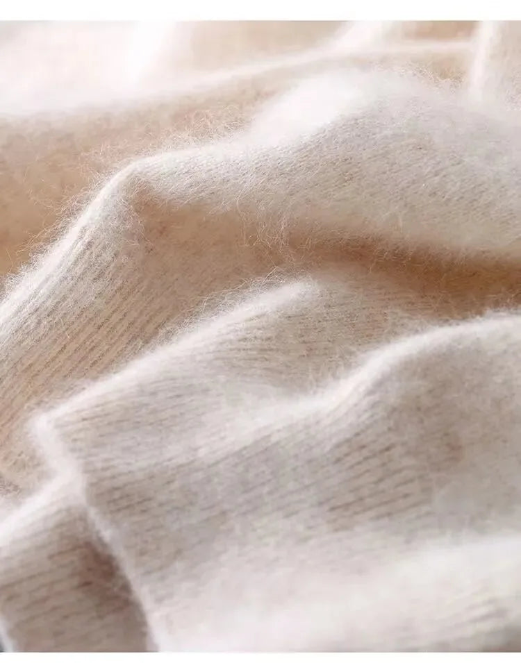 Close-up of beige knit fabric showing the soft, brushed texture and ribbed hem detail