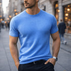 Front view of a man in a sky blue short-sleeve cashmere tee paired with a black belt and trousers