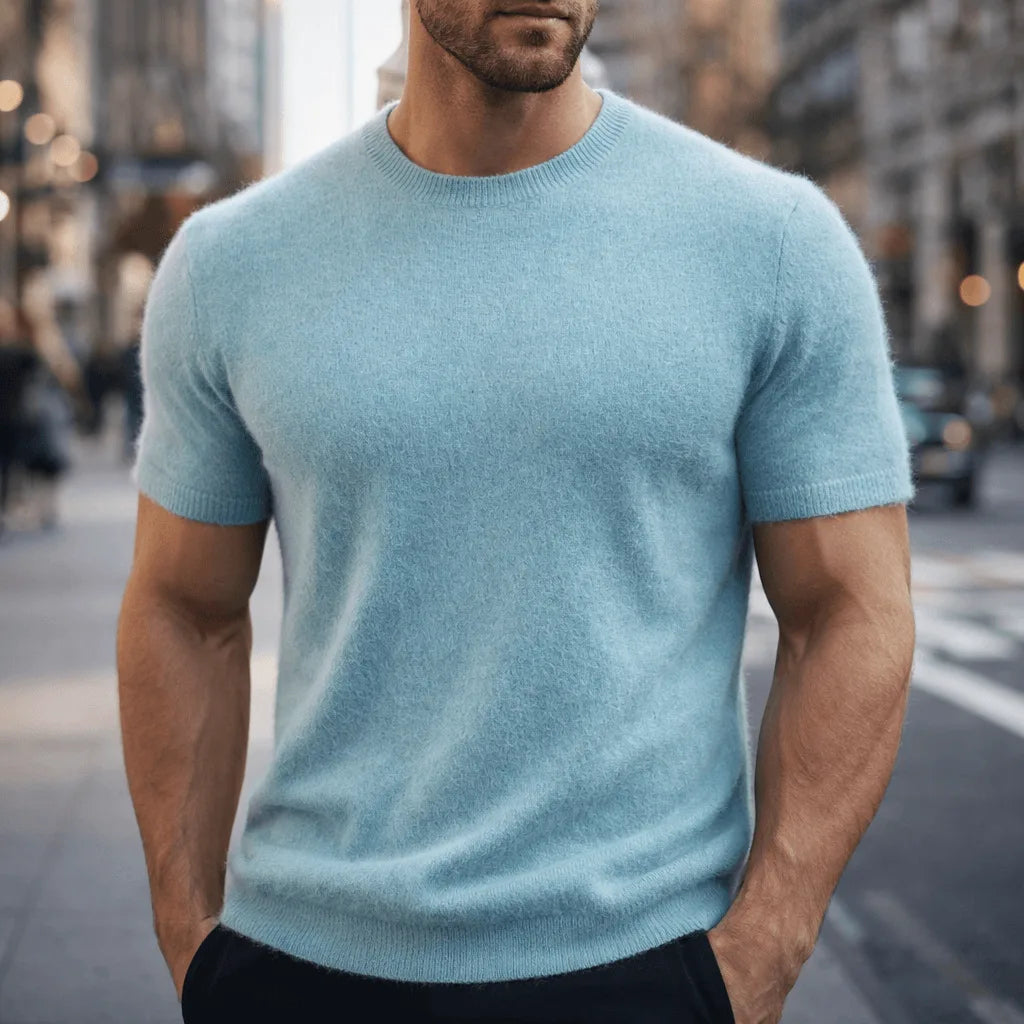 Man modelling a pale blue short-sleeve knit tee with a classic crew neck and fitted silhouette