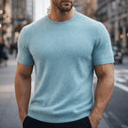 Man modelling a pale blue short-sleeve knit tee with a classic crew neck and fitted silhouette