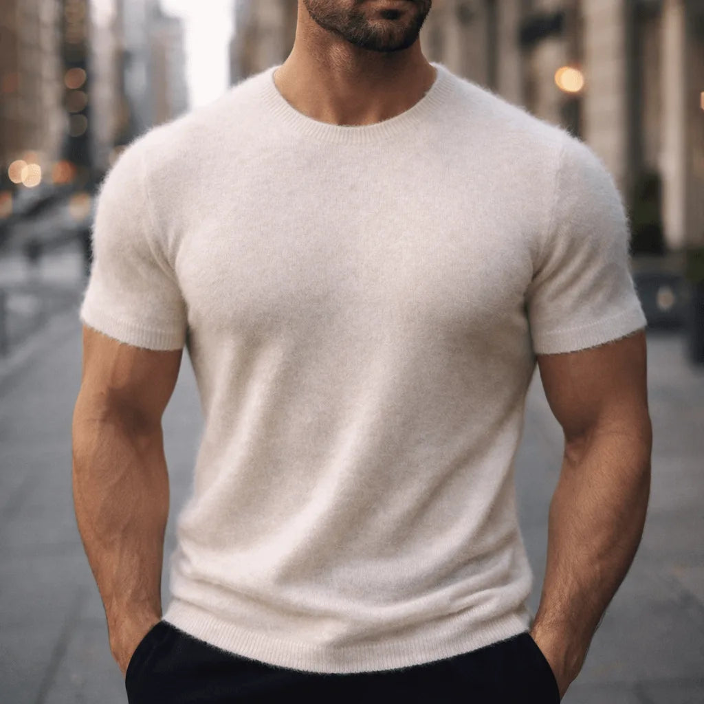Man wearing a cream coloured short-sleeve knit tee with visible soft, fuzzy knit texture