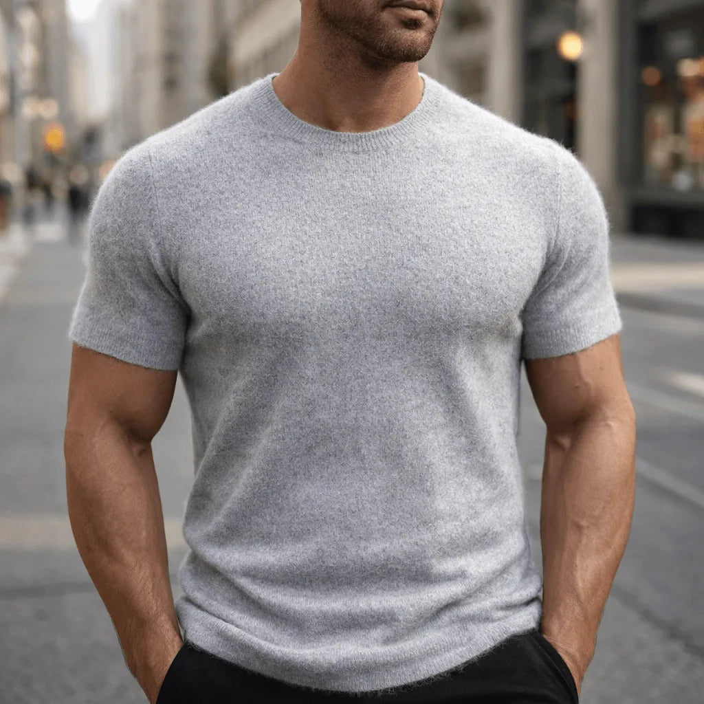 Close-up front view of a man in a light grey marle short-sleeve knit tee with ribbed trim