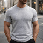Close-up front view of a man in a light grey marle short-sleeve knit tee with ribbed trim