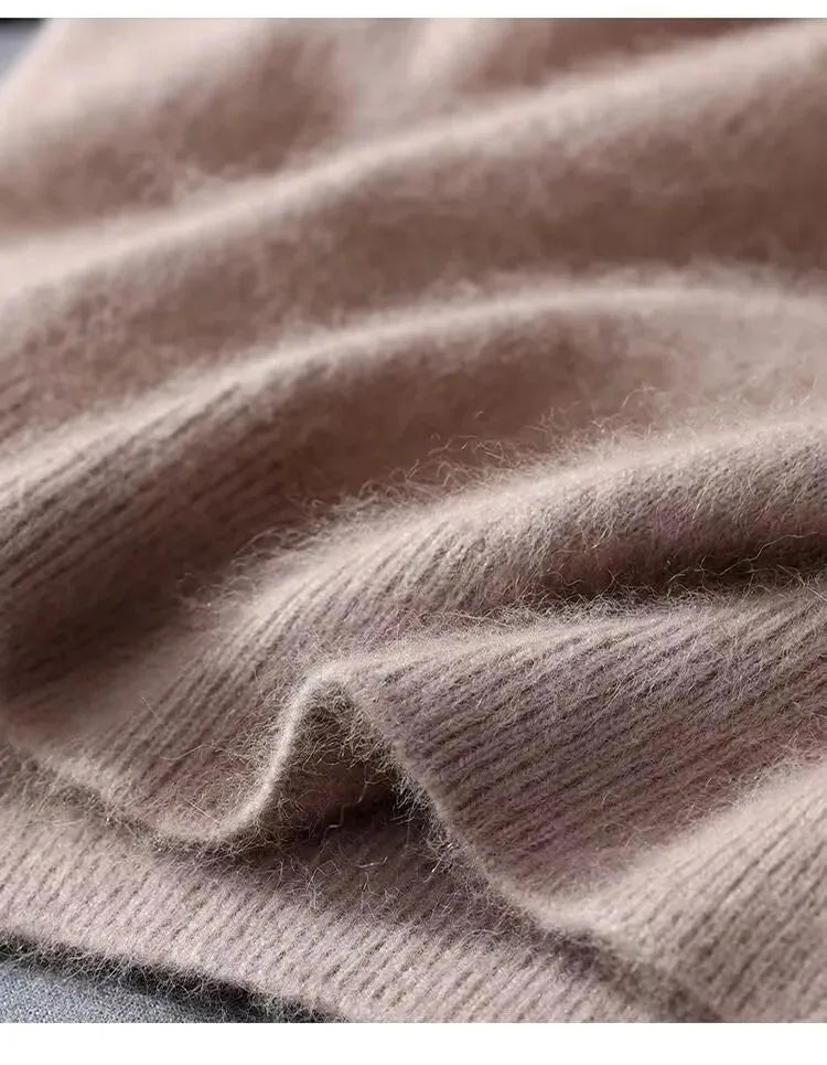 Close-up of soft taupe knit fabric folded to show the fine, brushed fibres and ribbed edge