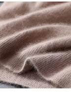 Close-up of soft taupe knit fabric folded to show the fine, brushed fibres and ribbed edge