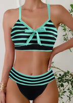 Mint green and black striped bikini with bow-tie front detail and matching high-waisted bottoms, front view.