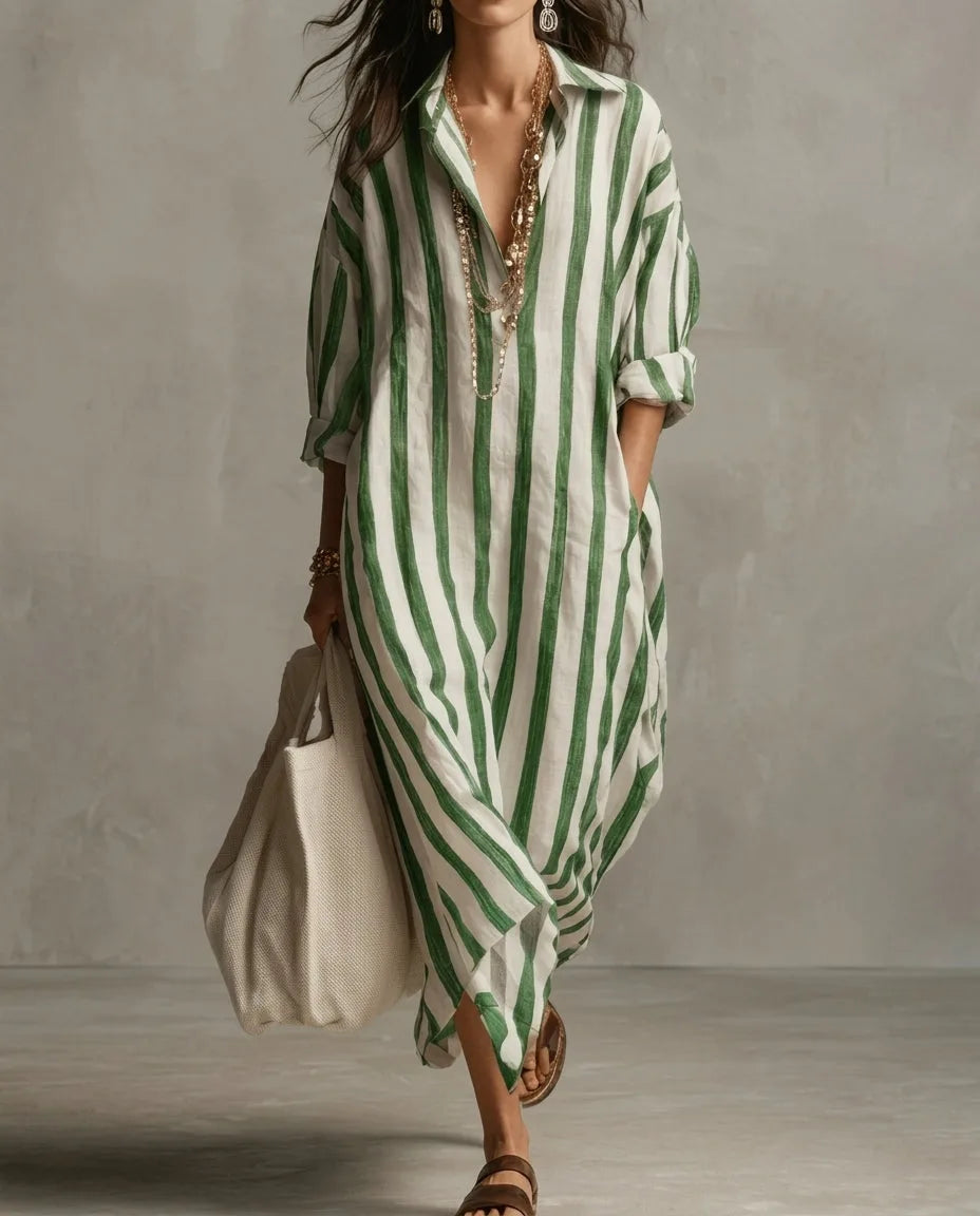 Front view of a green and white striped linen shirt dress with gold layered necklaces and tote bag