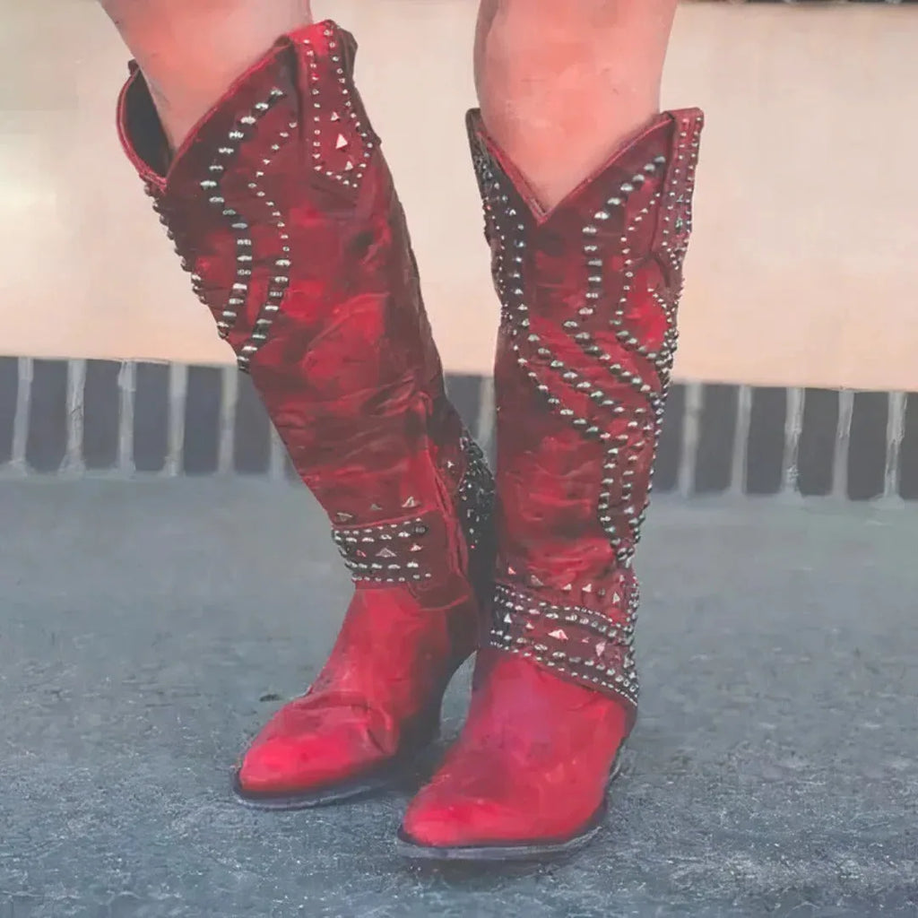 Front view of red leather studded cowboy boots with silver stud detailing and pointed toe