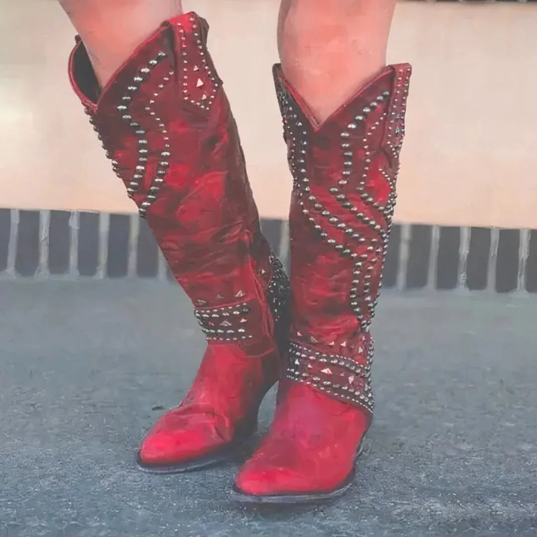 Front view of red leather studded cowboy boots with silver stud detailing and pointed toe