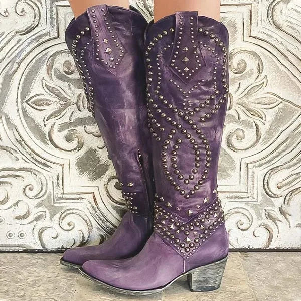 Purple leather studded knee-high cowboy boots with ornate stud pattern and block heel