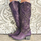 Purple leather studded knee-high cowboy boots with ornate stud pattern and block heel